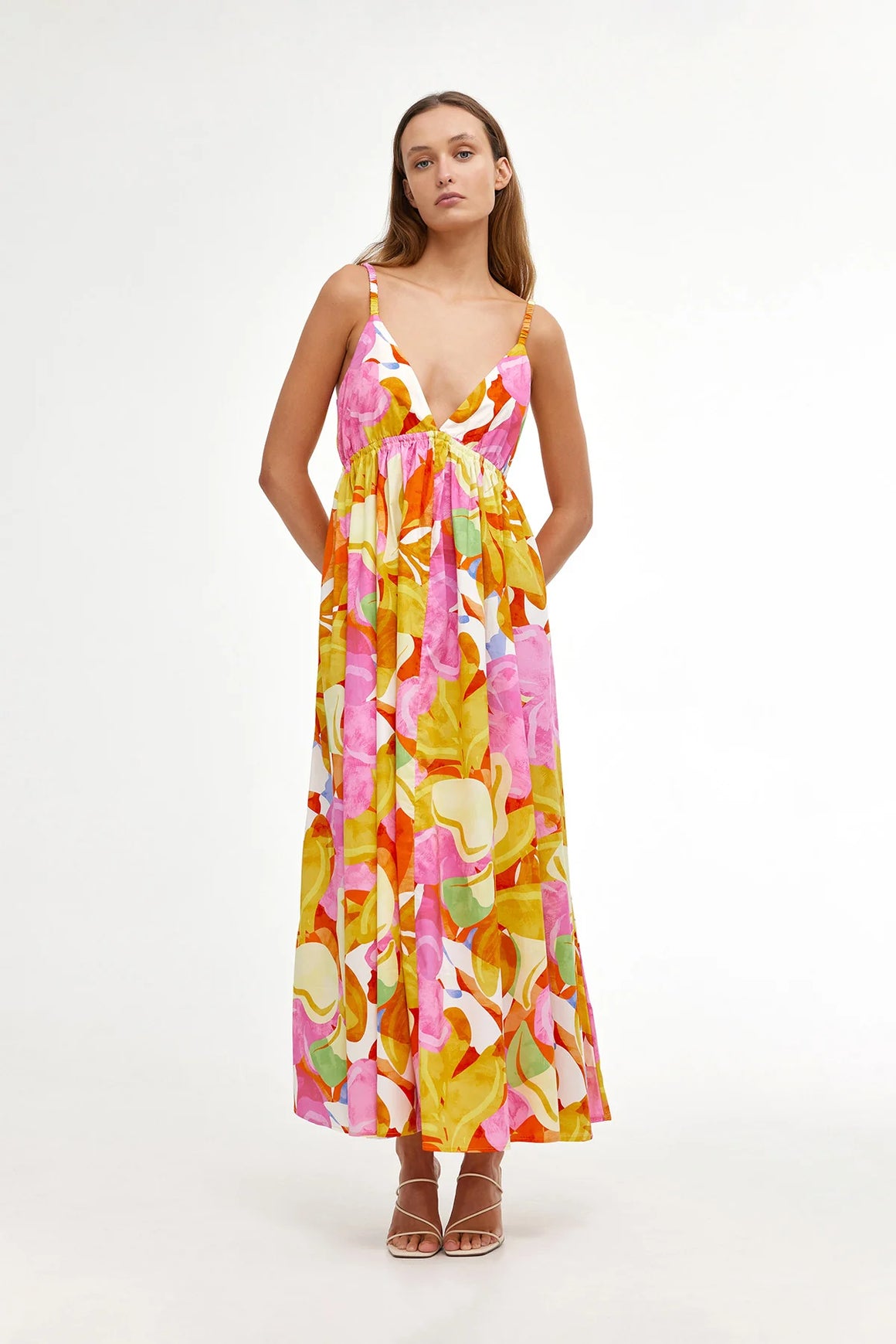 Maxi dress with thin shoulder straps and pink yellow orange floral pattern all over